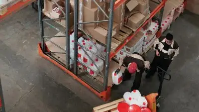 two guys doing stock management in a warehouse